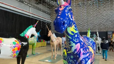 A group of decorated unicorn sculptures