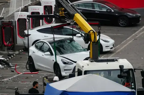 PA Media Damaged Tesla removed from scene