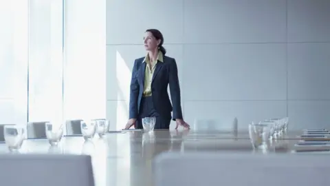 Getty Images/Martin Barraud Businesswoman in boardroom