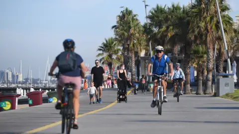 EPA People cycling along a promenade in Melbourne during the February lockdown
