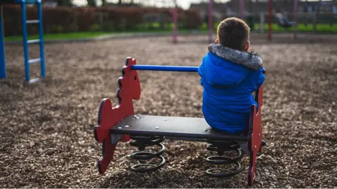 Getty Images Sad child in play park