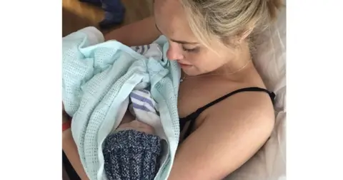 Elle Wright Elle holding her son, Teddy