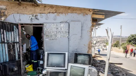 BBC/Shiraaz Mohamed Philimon Gwetekwete working in his TV repair shop in Alexandra township, Johannesburg, South Africa