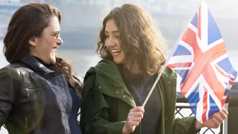 Getty Images Two friends laughing