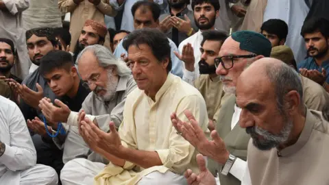 AFP/Getty Pakistani cricketer-turned-politician and head of the Pakistan Tehreek-i-Insaf (PTI) Imran Khan (L) prays with elder brother Aslam Raisani of Siraj Raisani, a candidate of provincial seat who was killed on July 13 suicide bombing in Mastung during an election campaign