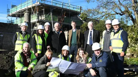 Barry Pells Conservation team in front of the West Mural Tower