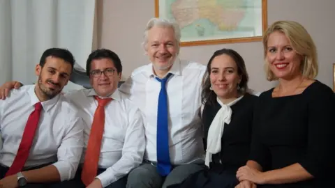 Wikileaks An undated photo issued by Wikileaks shows Julian Assange with his partner Stella Morris (to his left) alongside other members of his legal team