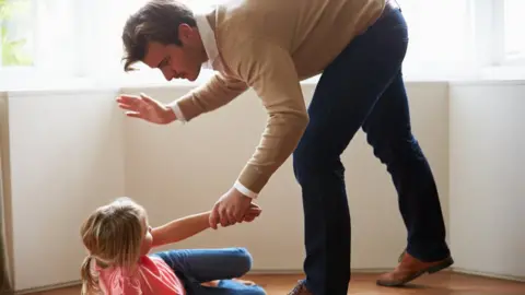 Getty Images Adult smacking child