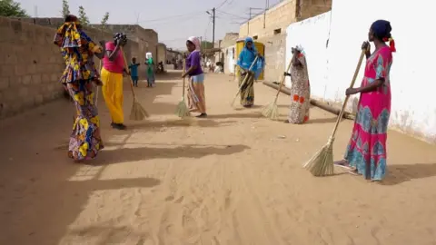 Women sweeping