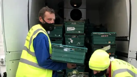 The Port Grocery CIC Stephen Shrimpton and another person help out with food bank van