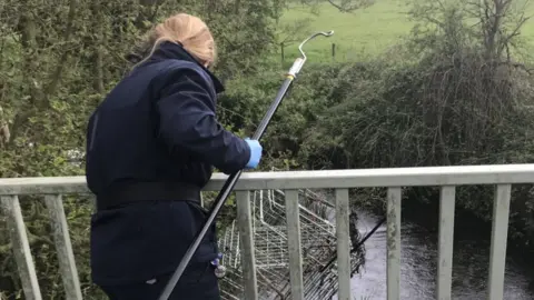 RSPCA Cage being removed from the stream