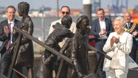 Joe Giddens/PA Wire Dame Stephanie Shirley (right) at the unveiling of a memorial to Kindertransport on the quayside at Harwich