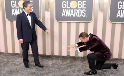 Getty Images Glass Onion director Rian Johnson bows down to fellow director Park Chan-wook, who helmed Decision To Leave