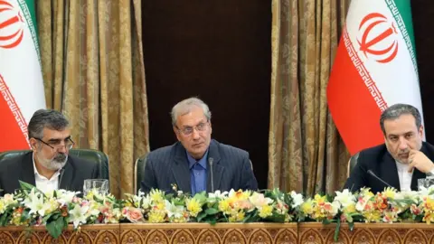 EPA Behrouz Kamalvandi, left, Ali Rabiei, centre, and Abbas Araqchi, right, address the press