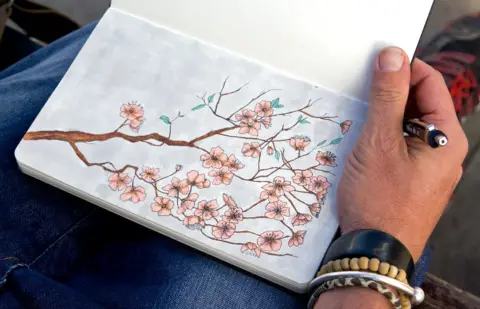 BBC Stephen O'Grady sketching in his pad