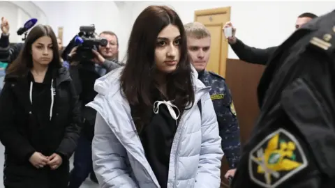 Getty Images Krestina (L) and Angelina, two of the Khachaturyan sisters charged with the murder of their father, during a hearing in Moscow