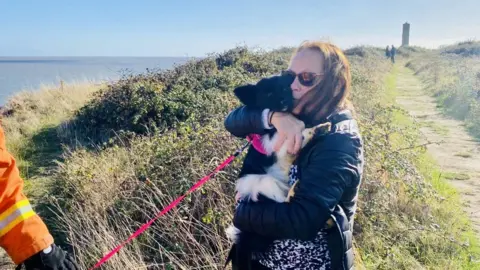 Essex County Fire and Rescue Service Woman with dog at Walton-on-the-Naze clifftop