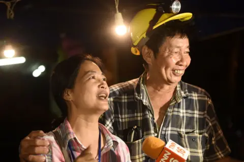 AFP Family members celebrate while camping out near Than Luang cave following news all members of children's football team and their coach were alive in the cave at Khun Nam Nang, 2 July