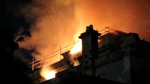 Elliot Ward fire sparks over the building