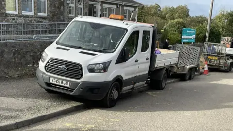 Peter Keam  A Wildanet van outside the village school