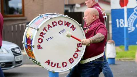 PAcemaker A man with a bald head playing a Lambeg drum in a parade in Portadown