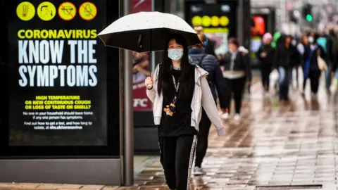 Getty Images Woman wearing mask in Edinburgh