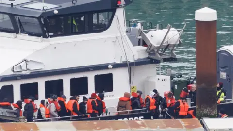 Getty Images Migrants being brought ashore at Dover on 17 January