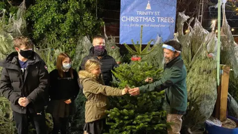 Trinity St Christmas Trees Pete Hyde selling Christmas tree to customers