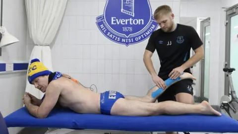 Everton FC Speedo Mick gets some treatment for sore feet by an Everton therapist