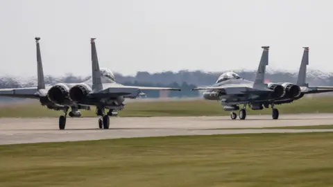 Getty Images Two F-15E Strike Eagles of the US Air Force line up to take off from RAF Lakenheath