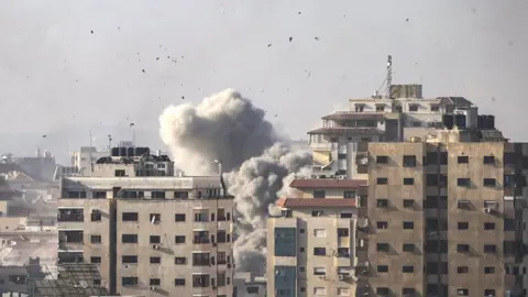 EPA Smoke rises following an Israeli air strike in northern Gaza, 20 October