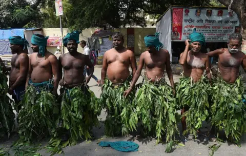 Getty Images Indian farmers from the southern state of Tamil Nadu wear tree leaves as they take part in a protest in Delhi