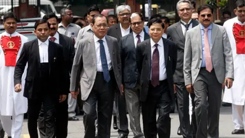 Getty Images Former Indian Chief Justices Dipak Misra and Ranjan Gogoi with other judges at an event in 2018