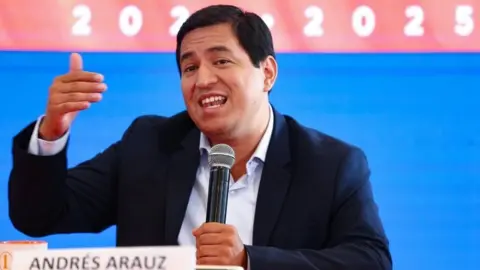 EPA Andres Arauz speaks at a news conference after obtaining the most votes in the first round of the 2021 presidential elections, in Quito, Ecuador, 09 February 2021.