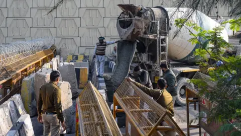 Getty Images Concrete being poured between stone barricades