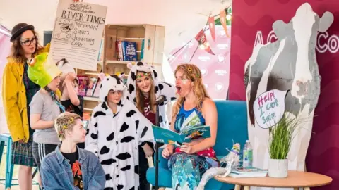 Bristol BID Woman dressed as a mermaid reads to children