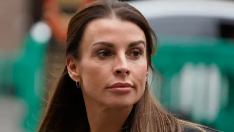 Coleen Rooney, wife of former England footballer Wayne Rooney, arrives to the High Court in central London for the start of the "Wagatha Christie" libel trial on May 10, 2022. - An online spat between top England footballers' wives Rebekah Vardy and Coleen Rooney over leaks to a tabloid newspaper has reached court.