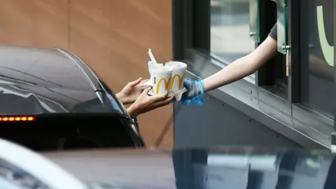 Getty Images drive through food handed from window to car