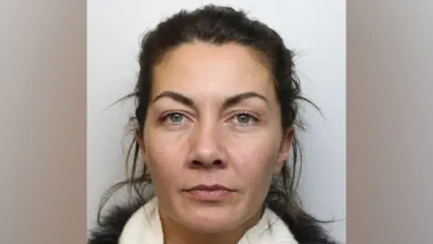 Wiltshire Police A woman with brown hair in a white scarf