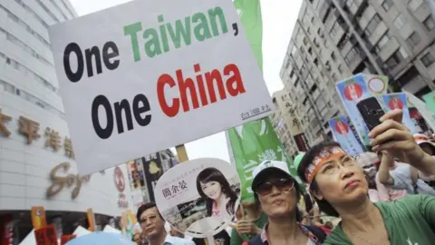 Associated Press In this June 26, 2010 file photo, anti-China demonstrators hold placards denouncing the Economic Cooperation Framework Agreement (ECFA) planned with China, in Taipei, Taiwan.