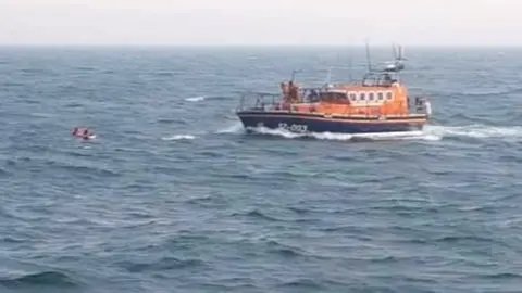 Wells Lifeboat Service Men in sea