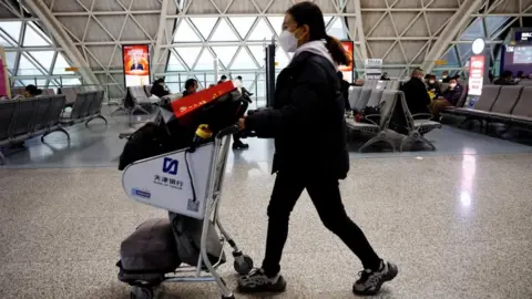 Reuters A passenger at Chengdu International Airport in China on 30 December