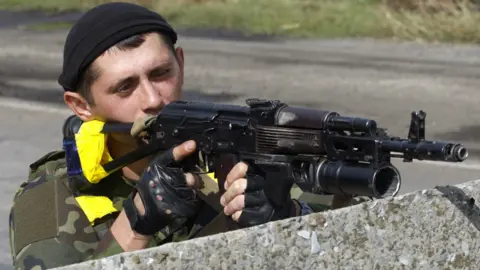 AFP Ukrainian soldier at checkpoint near Slavyanoserbsk, eastern Ukraine, 10 Sep 14