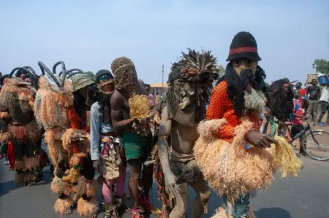 AMOS GUMULIRA/AFP Gulewamkulu dancers of Malawi line up during a street cultural march at the beginning of the Chewa Heritage Foundation Cultural Day in Lilongwe, on October 14, 2023.
