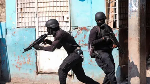 Police officers with guns in Port-au-Prince