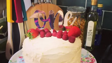 Family photo Violet's first birthday cake