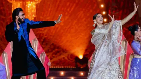 Reuters Actor Ranveer Singh and his wife and actor Deepika Padukone perform during the pre-wedding celebrations of Anant Ambani, son of Mukesh Ambani, the Chairman of Reliance Industries, and Radhika Merchant, daughter of industrialist Viren Merchant, in Jamnagar, Gujarat, India, March 2, 2024