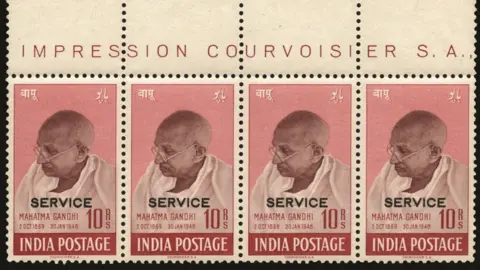 Stanley Gibbons Strip of four 1948 Gandhi 10 rupee Purple-Brown and Lake ‘SERVICE’ stamps