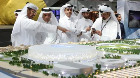 Reuters Qatar Airways Chief Executive Akbar al-Baker looks at a model of Al Thumama stadium during a ceremony at Hamad International Airport in Doha, Qatar (24 August 2017)