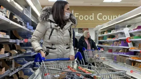 PA Media Woman shopping at Tesco